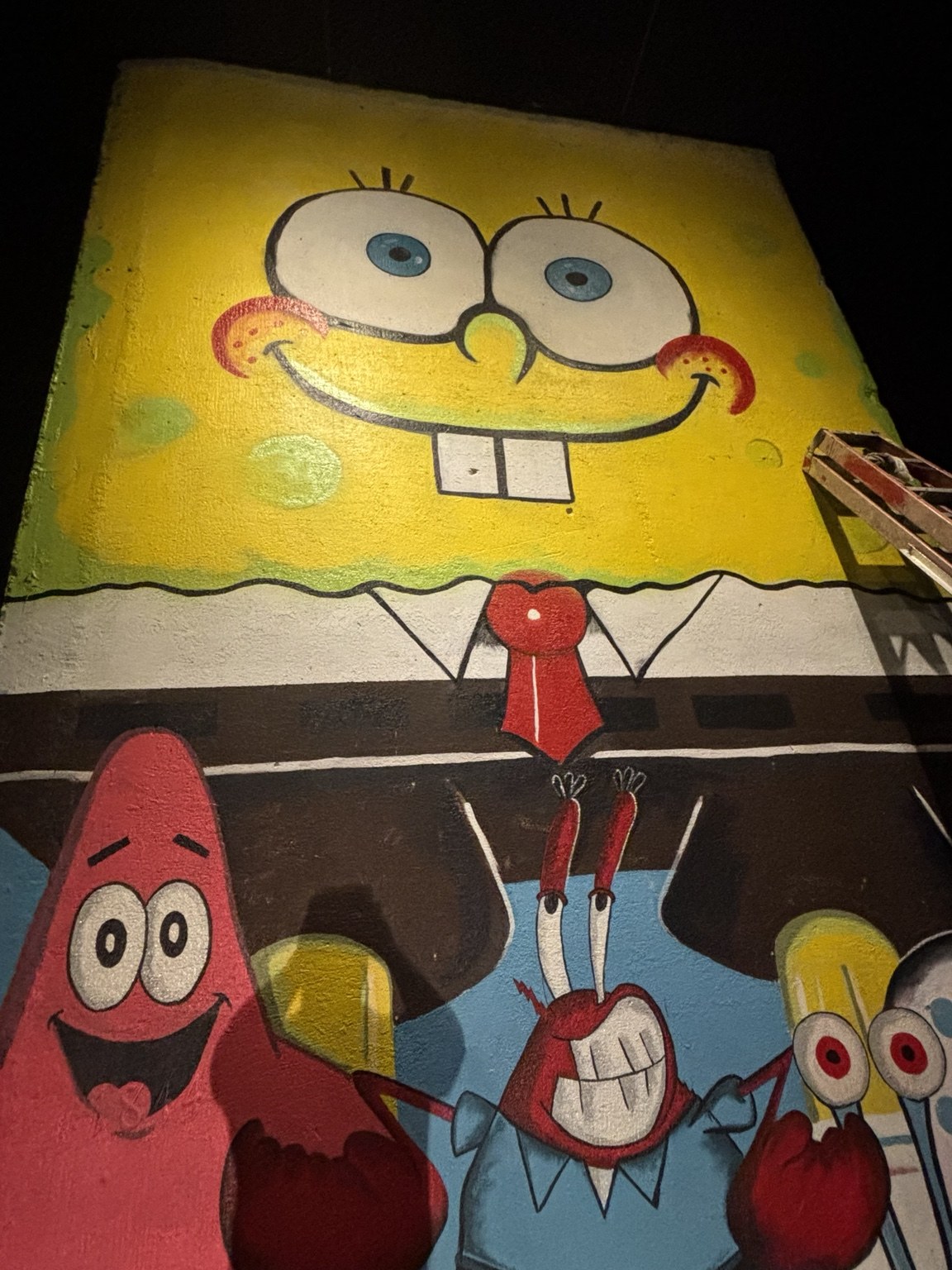 SpongeBob, Patrick, Mr. Krabs, and Gary painted on the colorful Carnival Treats mural